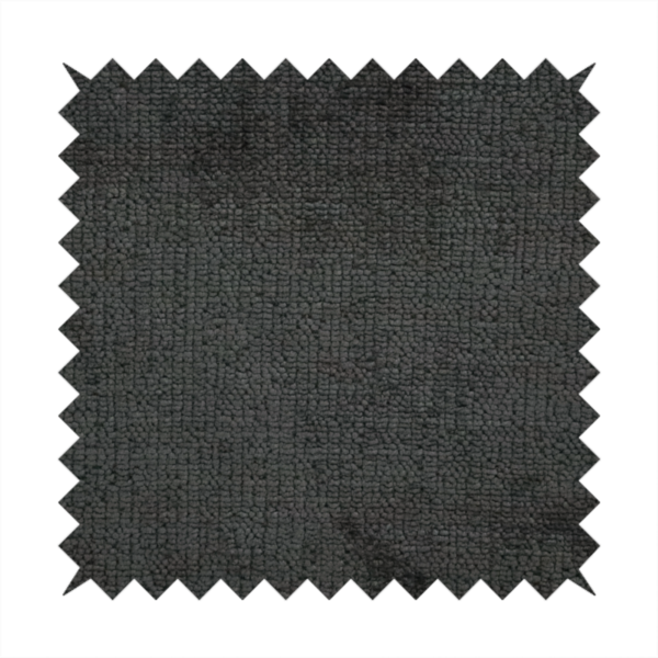 A textured fabric swatch in a very dark anthracite or charcoal grey colour. The material features a dense, uniform nubby weave with deep, almost black shading variations, creating a rich, moody, and sophisticated appearance.