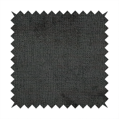 A textured fabric swatch in a very dark anthracite or charcoal grey colour. The material features a dense, uniform nubby weave with deep, almost black shading variations, creating a rich, moody, and sophisticated appearance.