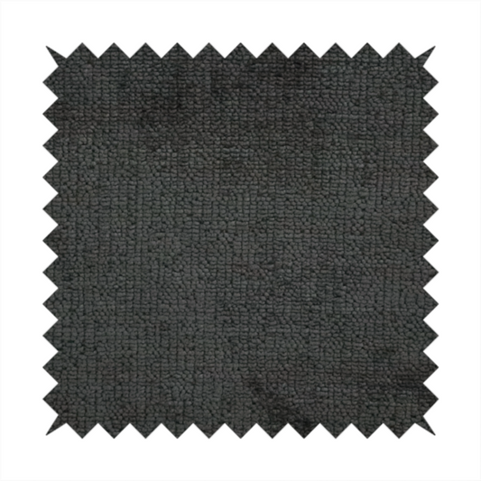 A textured fabric swatch in a very dark anthracite or charcoal grey colour. The material features a dense, uniform nubby weave with deep, almost black shading variations, creating a rich, moody, and sophisticated appearance.