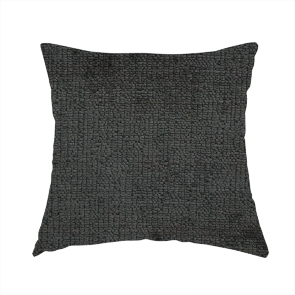 The fabric used to create this handmade cushion is a textured fabric swatch in a very dark anthracite or charcoal grey colour. The material features a dense, uniform nubby weave with deep, almost black shading variations, creating a rich, moody, and sophisticated appearance.