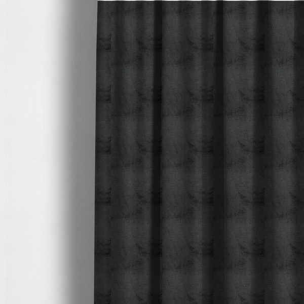 The fabric used to create these made-to-measure curtains is a textured fabric swatch in a very dark anthracite or charcoal grey colour. The material features a dense, uniform nubby weave with deep, almost black shading variations, creating a rich, moody, and sophisticated appearance.