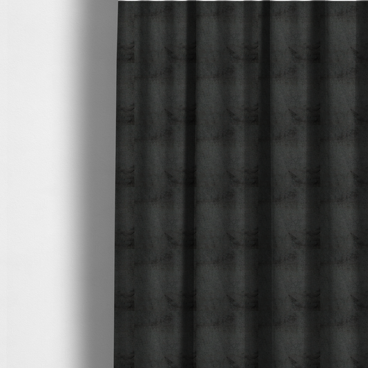 The fabric used to create these made-to-measure curtains is a textured fabric swatch in a very dark anthracite or charcoal grey colour. The material features a dense, uniform nubby weave with deep, almost black shading variations, creating a rich, moody, and sophisticated appearance.