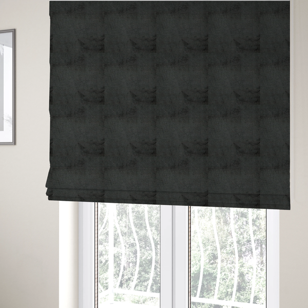 The fabric used to create these Roman blinds is a textured fabric swatch in a very dark anthracite or charcoal grey colour. The material features a dense, uniform nubby weave with deep, almost black shading variations, creating a rich, moody, and sophisticated appearance.