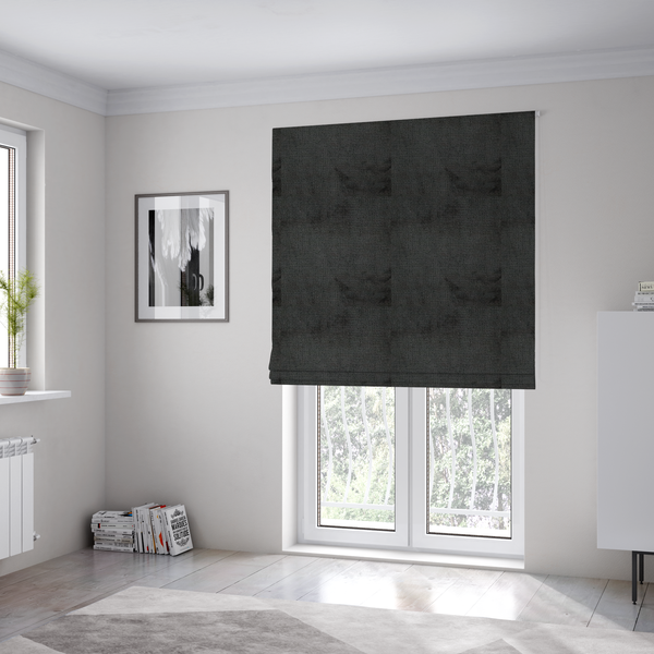 The fabric used to create these Roman blinds is a textured fabric swatch in a very dark anthracite or charcoal grey colour. The material features a dense, uniform nubby weave with deep, almost black shading variations, creating a rich, moody, and sophisticated appearance.