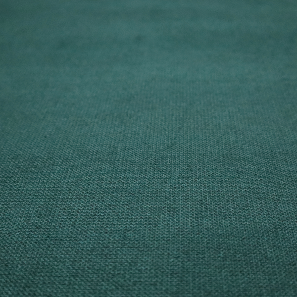 A textured teal fabric with a visible tight weave.