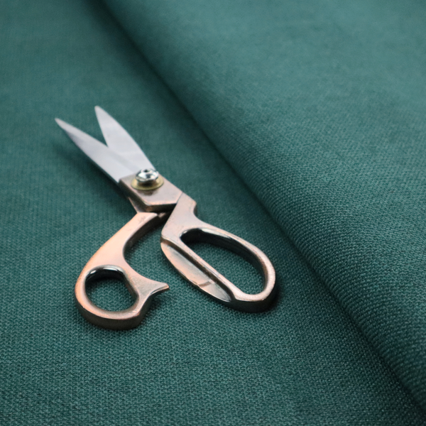 A textured teal fabric with a visible tight weave.