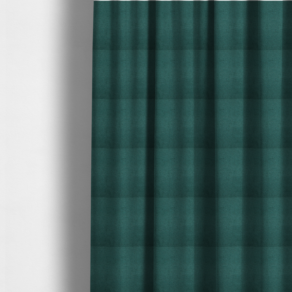 The fabric used to create these made-to-measure curtains is a textured teal fabric with a visible tight weave.