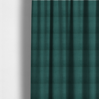 The fabric used to create these made-to-measure curtains is a textured teal fabric with a visible tight weave.