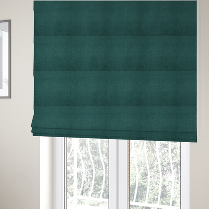 The fabric used to create these Roman blinds is a textured teal fabric with a visible tight weave.