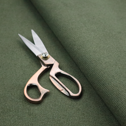 A textured moss green fabric with a tight, uniform weave.
