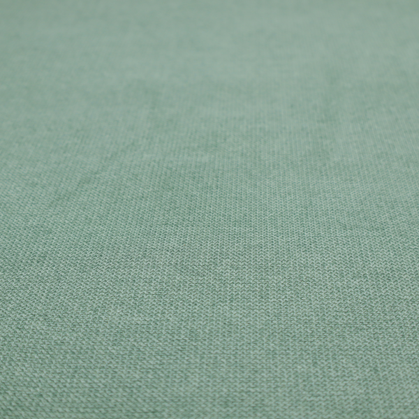 A textured sage or mint green fabric with a tight, uniform weave.