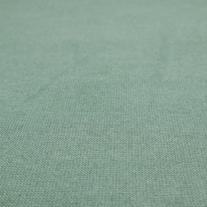 A textured sage or mint green fabric with a tight, uniform weave.