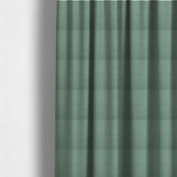 The fabric used to create these made-to-measure curtains is a textured sage or mint green fabric with a tight, uniform weave.