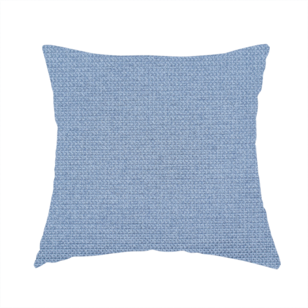 The fabric used to create this handmade cushion is a textured cornflower blue fabric with a tight, uniform cross-weave.