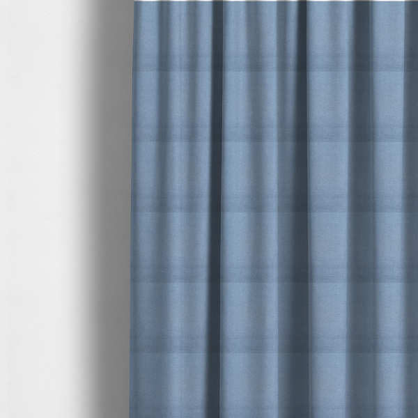 The fabric used to create these made-to-measure curtains is a textured cornflower blue fabric with a tight, uniform cross-weave.
