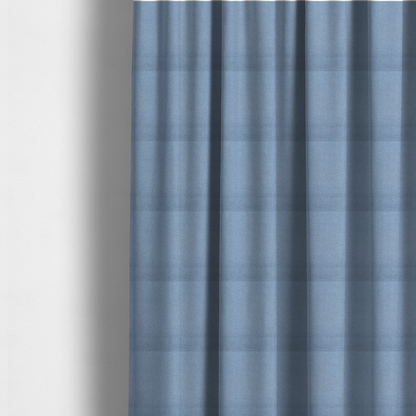 The fabric used to create these made-to-measure curtains is a textured cornflower blue fabric with a tight, uniform cross-weave.