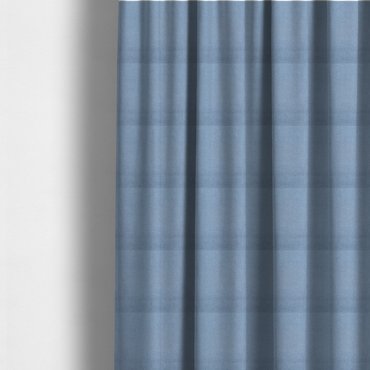 The fabric used to create these made-to-measure curtains is a textured cornflower blue fabric with a tight, uniform cross-weave.