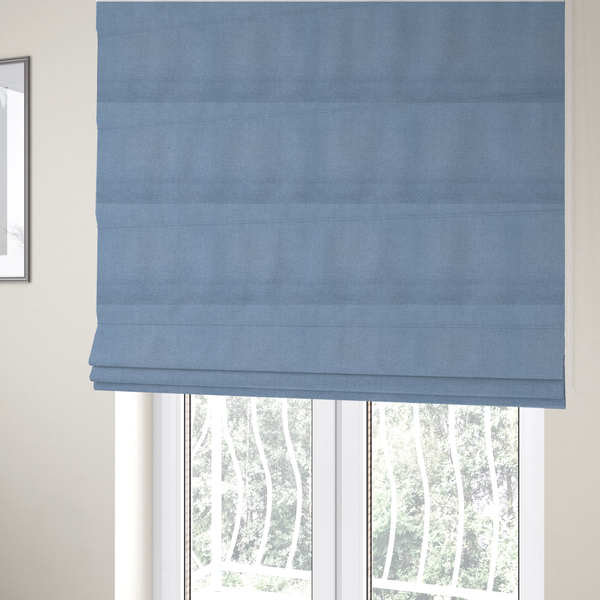 The fabric used to create these Roman blinds is a textured cornflower blue fabric with a tight, uniform cross-weave.