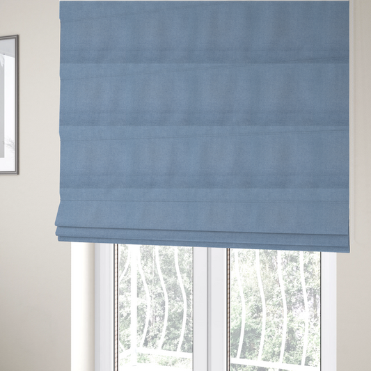 The fabric used to create these Roman blinds is a textured cornflower blue fabric with a tight, uniform cross-weave.