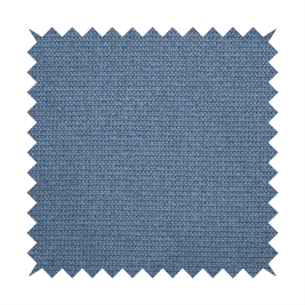 A textured denim blue fabric with a tight, uniform cross-weave pattern.