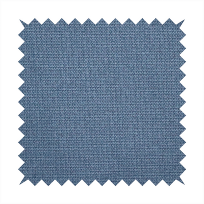 A textured denim blue fabric with a tight, uniform cross-weave pattern.