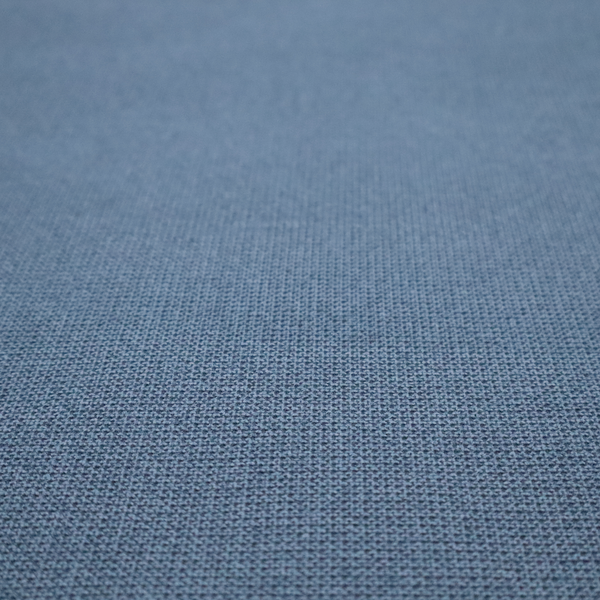 A textured denim blue fabric with a tight, uniform cross-weave pattern.