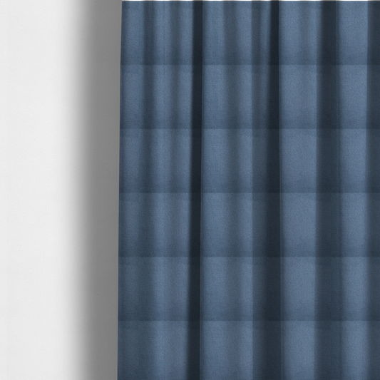 The fabric used to create these made-to-measure curtains is a textured denim blue fabric with a tight, uniform cross-weave pattern.