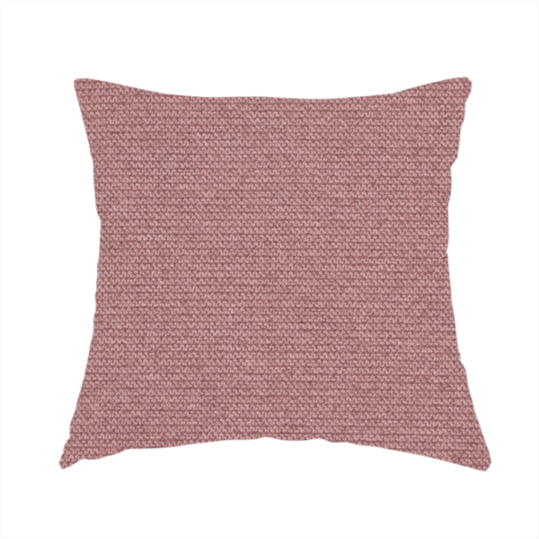 The fabric used to create this handmade cushion is a textured dusty pink fabric with a tight, uniform weave.