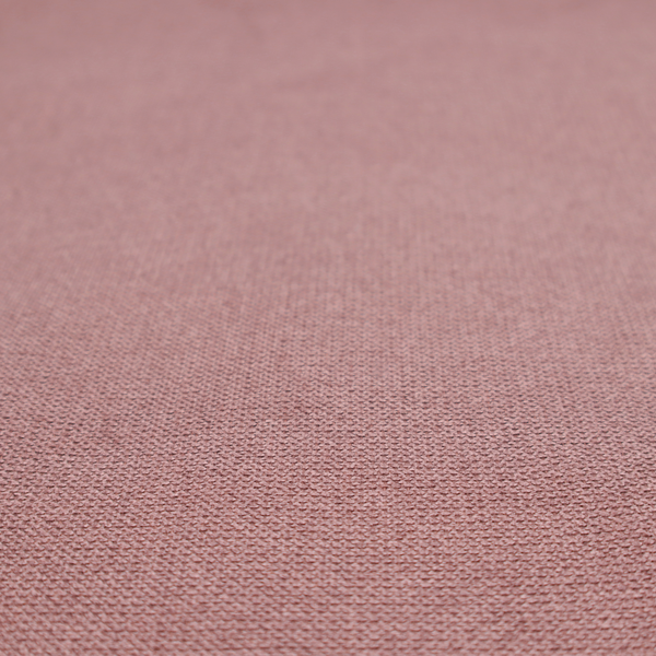 A textured dusty pink fabric with a tight, uniform weave.