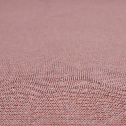 A textured dusty pink fabric with a tight, uniform weave.