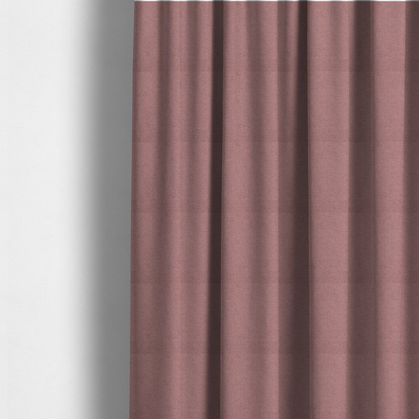 The fabric used to create these made-to-measure curtains is a textured dusty pink fabric with a tight, uniform weave.