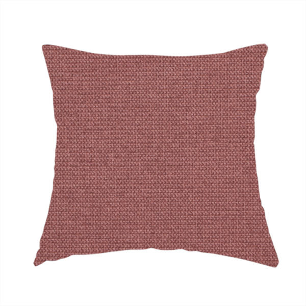 The fabric used to create this handmade cushion is a textured terracotta pink fabric with a tight, uniform cross-weave.