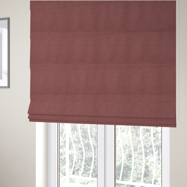 The fabric used to create these Roman blinds is a textured terracotta pink fabric with a tight, uniform cross-weave.