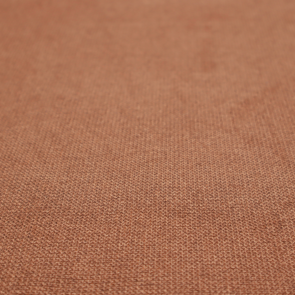 A textured terracotta orange fabric with a tight, uniform weave.