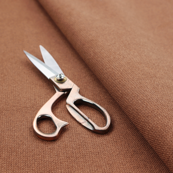 A textured terracotta orange fabric with a tight, uniform weave.