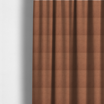 The fabric used to create these made-to-measure curtains is a textured terracotta orange fabric with a tight, uniform weave.