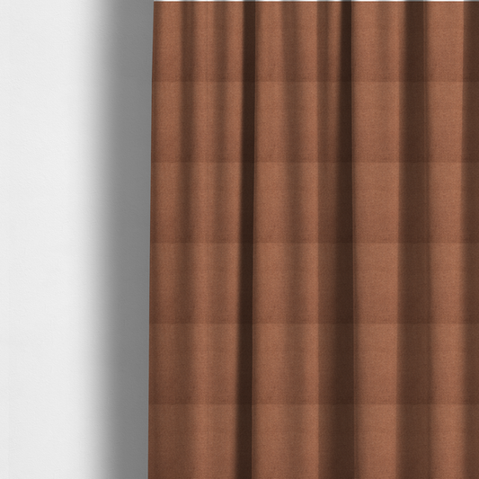 The fabric used to create these made-to-measure curtains is a textured terracotta orange fabric with a tight, uniform weave.