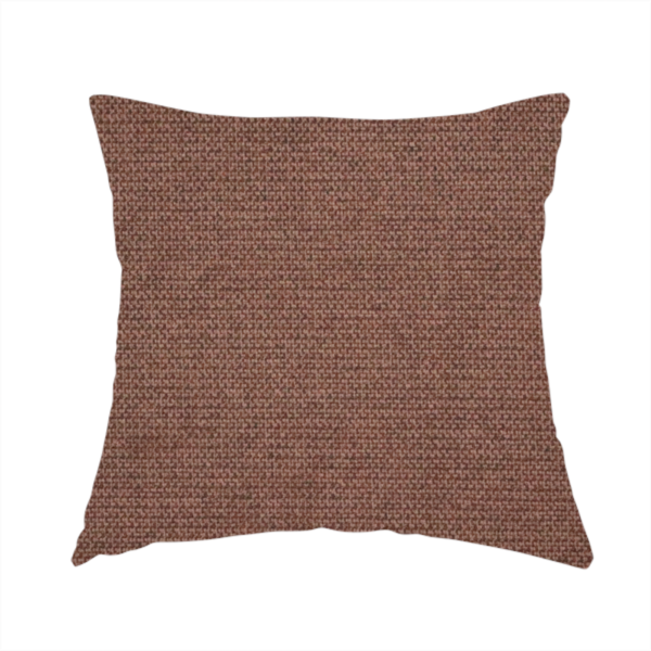 The fabric used to create this handmade cushion is a textured dark terracotta brown fabric with a tight, uniform cross-weave.