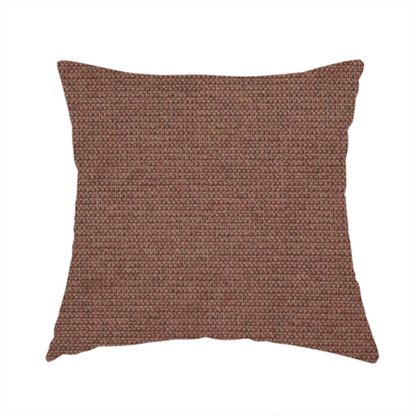 The fabric used to create this handmade cushion is a textured dark terracotta brown fabric with a tight, uniform cross-weave.