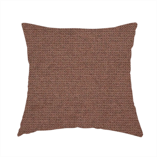 The fabric used to create this handmade cushion is a textured dark terracotta brown fabric with a tight, uniform cross-weave.