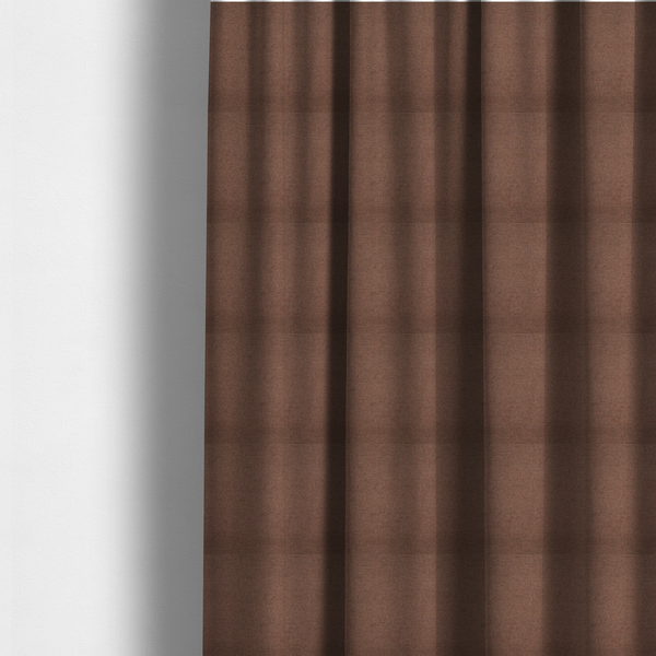 The fabric used to create these made-to-measure curtains is a textured dark terracotta brown fabric with a tight, uniform cross-weave.
