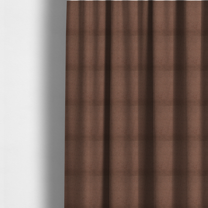 The fabric used to create these made-to-measure curtains is a textured dark terracotta brown fabric with a tight, uniform cross-weave.