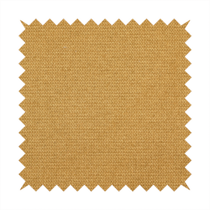A textured mustard yellow fabric with a tight, uniform weave.