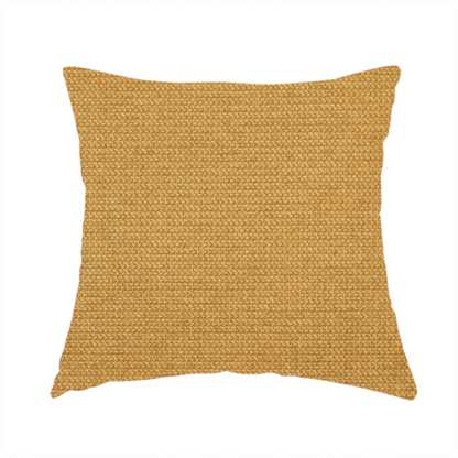 The fabric used to create this handmade cushion is a textured mustard yellow fabric with a tight, uniform weave.