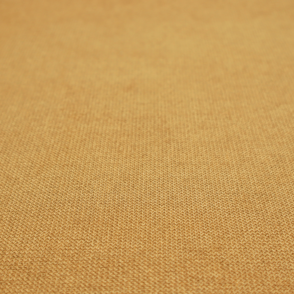 A textured mustard yellow fabric with a tight, uniform weave.