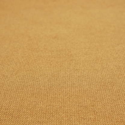 A textured mustard yellow fabric with a tight, uniform weave.