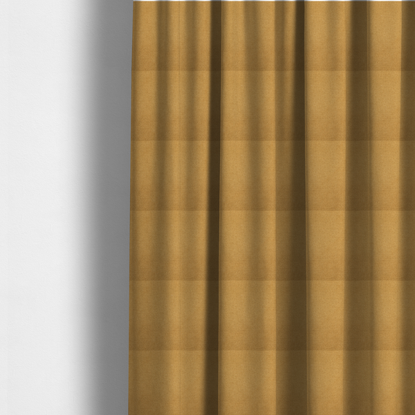 The fabric used to create these made-to-measure curtains is a textured mustard yellow fabric with a tight, uniform weave.
