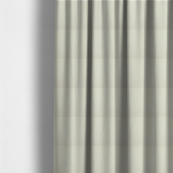 The fabric used to create these made-to-measure curtains is a textured cream-coloured fabric with a tight, uniform cross-weave.
