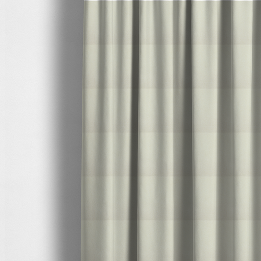 The fabric used to create these made-to-measure curtains is a textured cream-coloured fabric with a tight, uniform cross-weave.