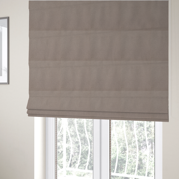 The fabric used to create these Roman blinds is a textured taupe fabric with a tight, uniform cross-weave.
